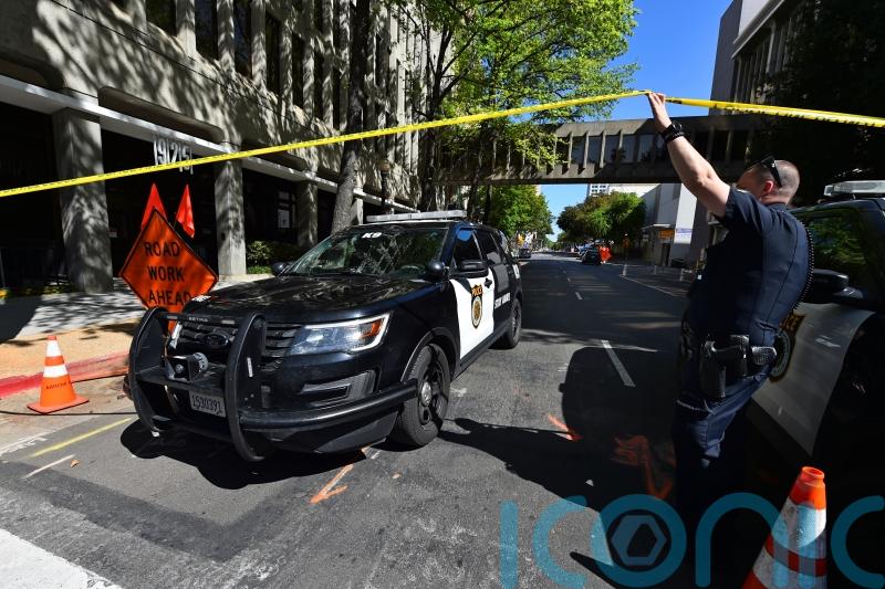 California police continue search for gunmen who killed six and hurt 12