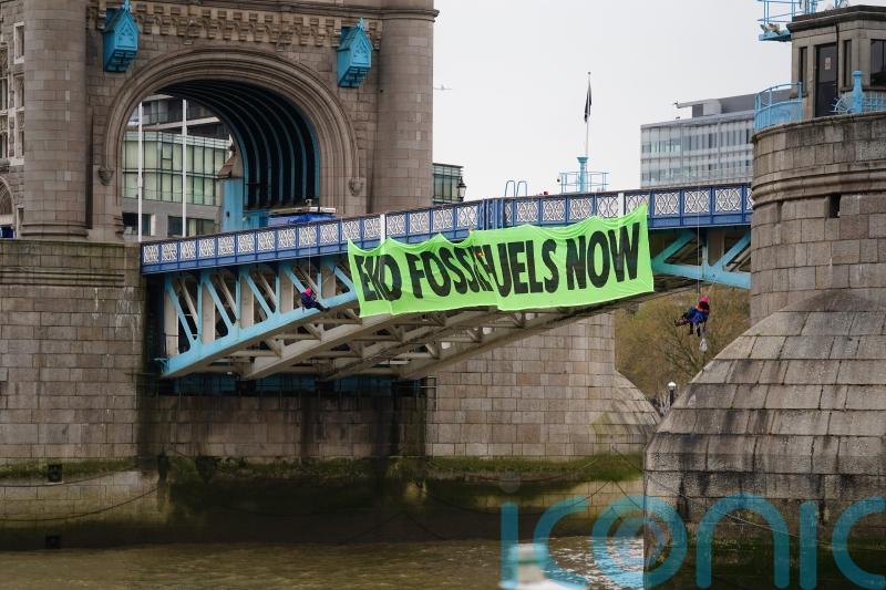 Extinction Rebellion activists abseil off Tower Bridge in climate protest