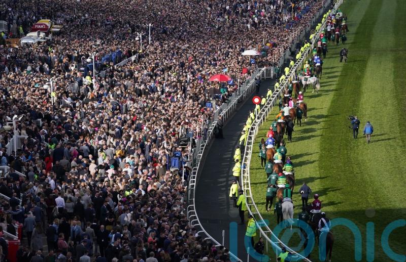 Sell-out crowd cheers on Grand National as punters return to races