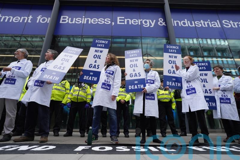 Activists glue themselves to Government building in climate protest