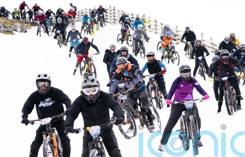 Hundreds of daring mountain bikers in 900m descent of snow-capped mountain