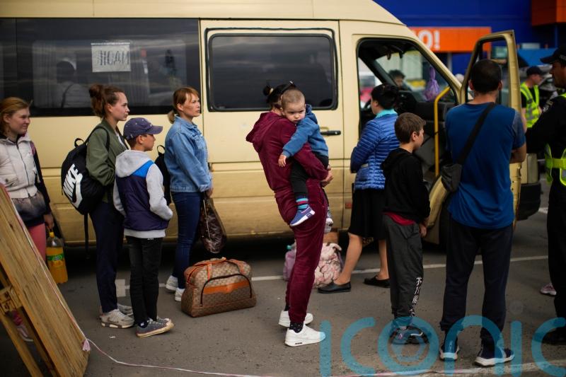 Aid workers prepare stretchers and toys for Mariupol evacuees