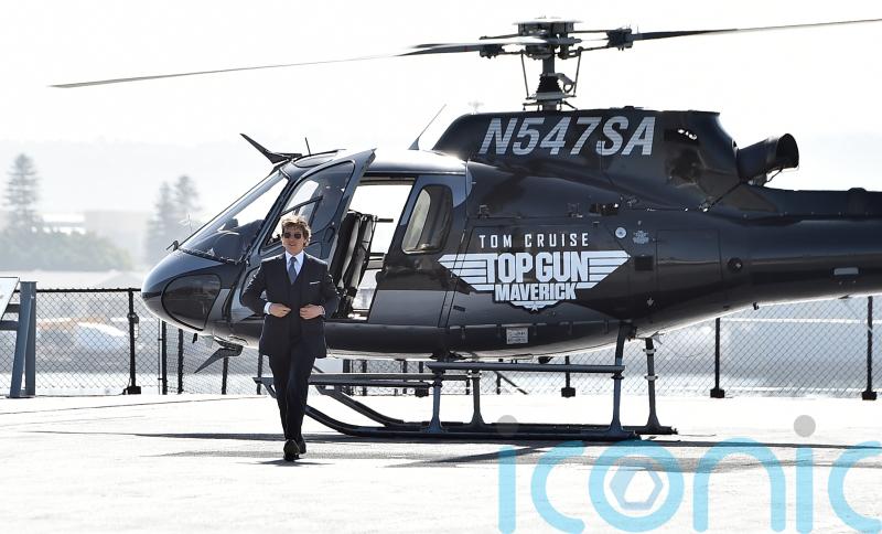 Tom Cruise lands helicopter on aircraft carrier for Top Gun sequel red carpet