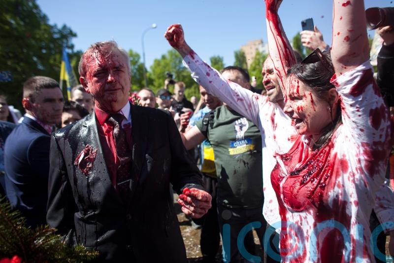 Russian ambassador to Poland hit with red paint by protesters