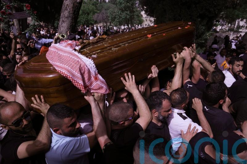 Pallbearers drop journalist’s coffin as Israeli police hit mourners with batons