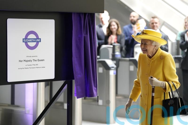 Queen beams in sunshine yellow for surprise visit to open Elizabeth line