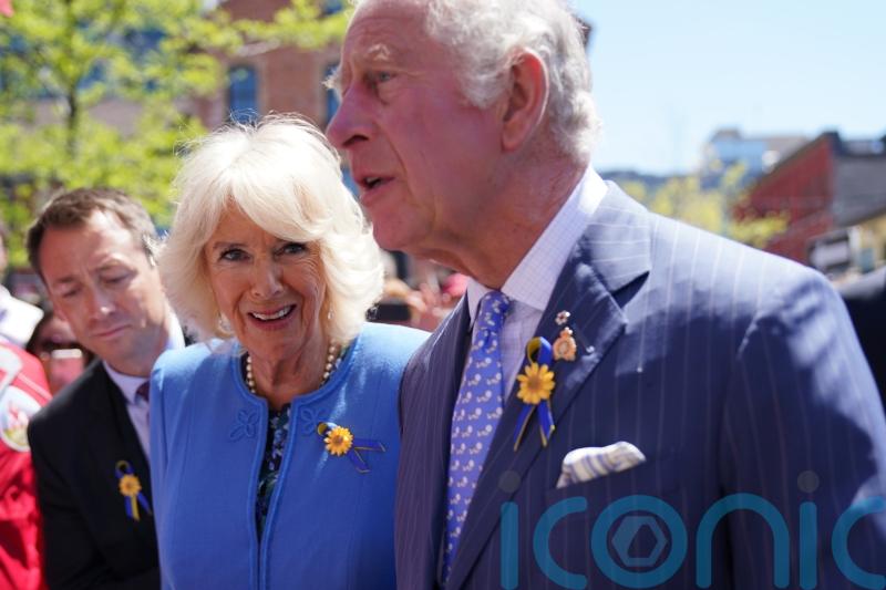 Camilla laughs after being presented with stress ball made from beaver fur