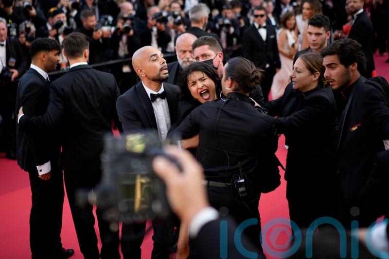 Woman strips off in Cannes red carpet protest
