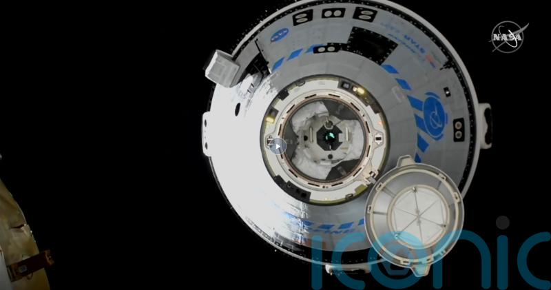 Boeing docks crew capsule to space station for first time