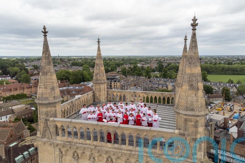 Choir sings from top of 163ft tower at Cambridge college