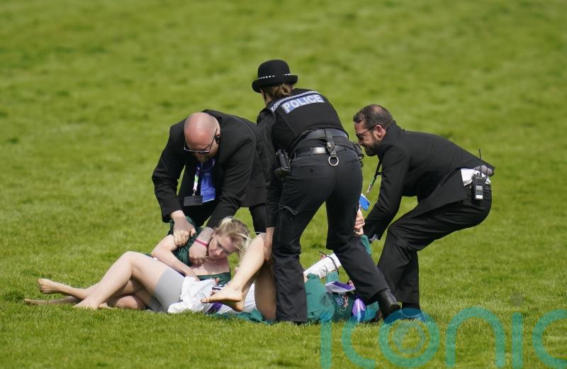 Animal activists taken away by police after running on track at Epsom Derby