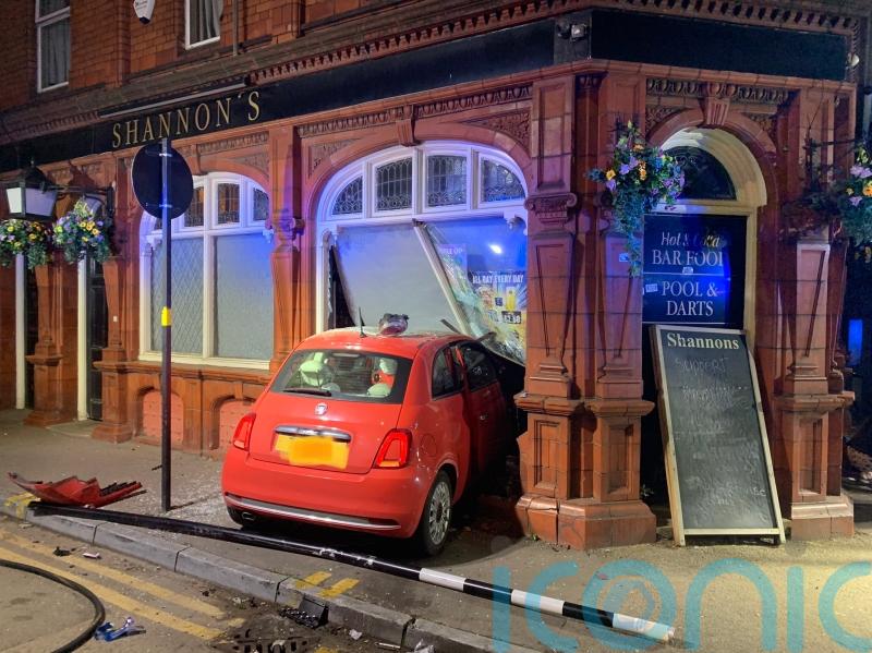 Two taken to hospital after car crashes into pub