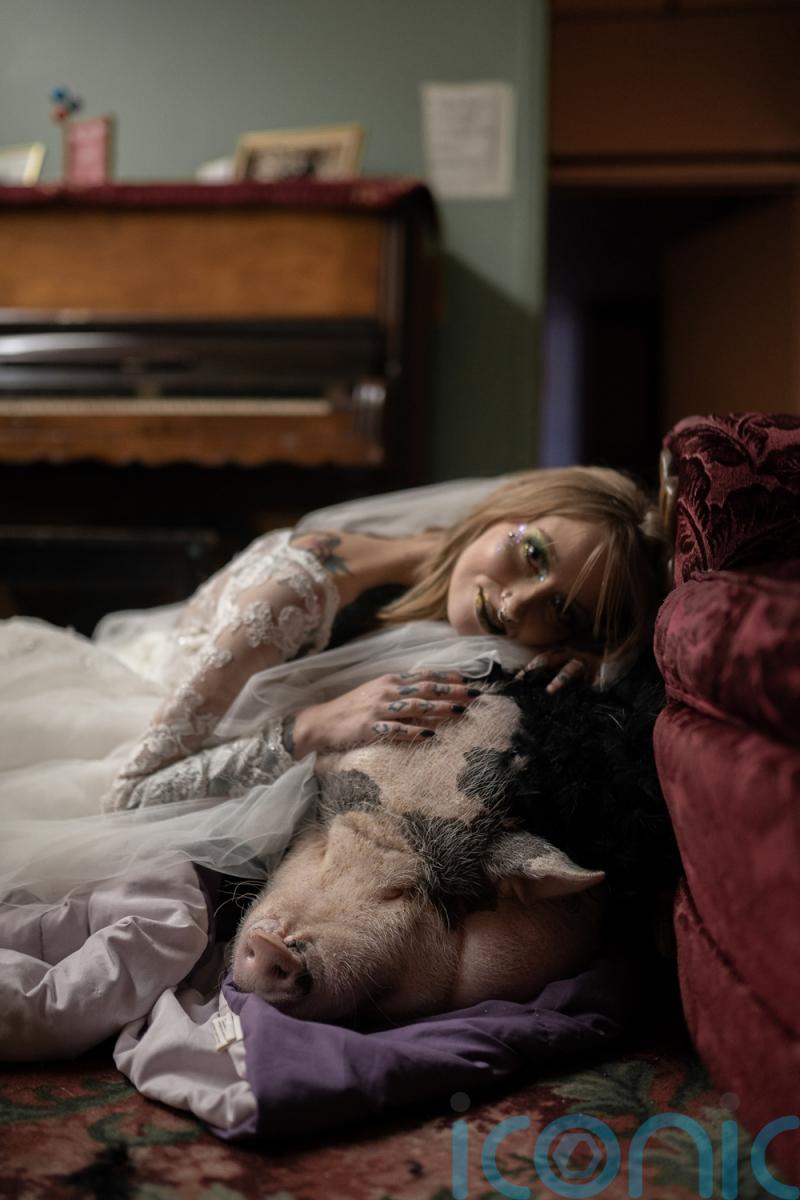 Mum with poker face caused by genetic condition smiles inside when she weds and pet pig is ring bearer