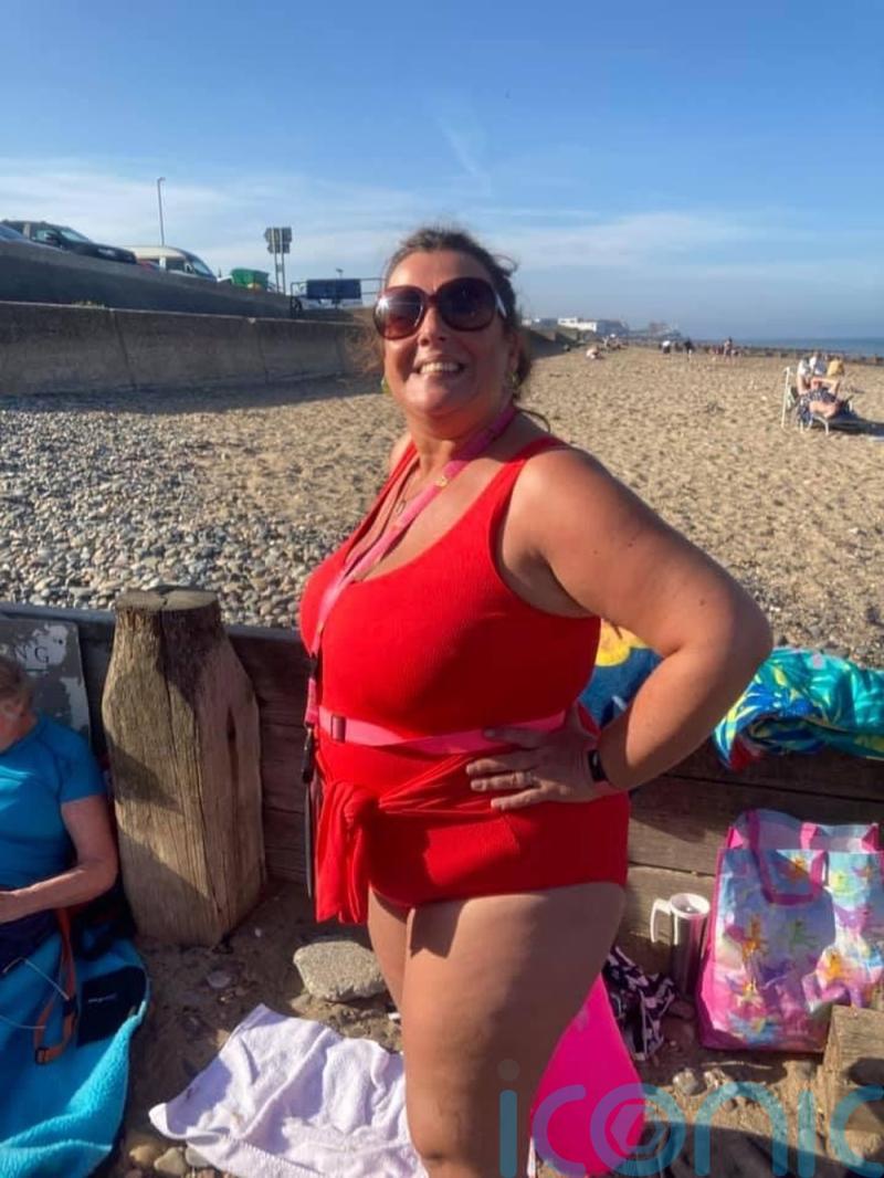 Self-conscious sea swimmer swaps sunrise or sunset dips in full wetsuit to lead 900-strong women’s open water group in bright pink costume