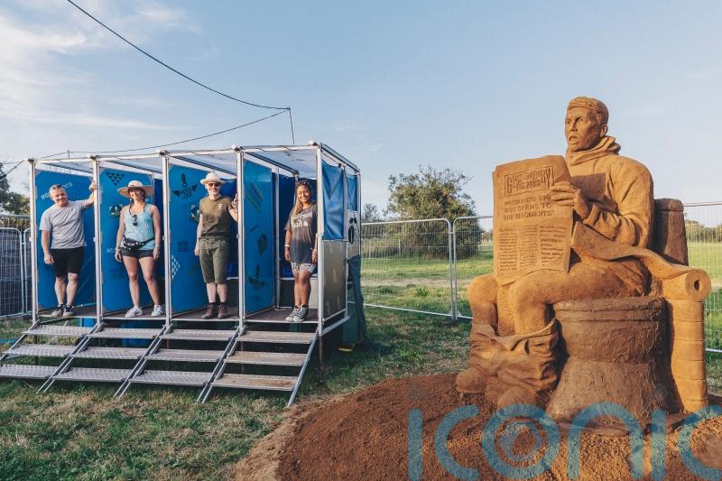 Huge mud toilet sculpture unveiled at Glastonbury to warn against climate change