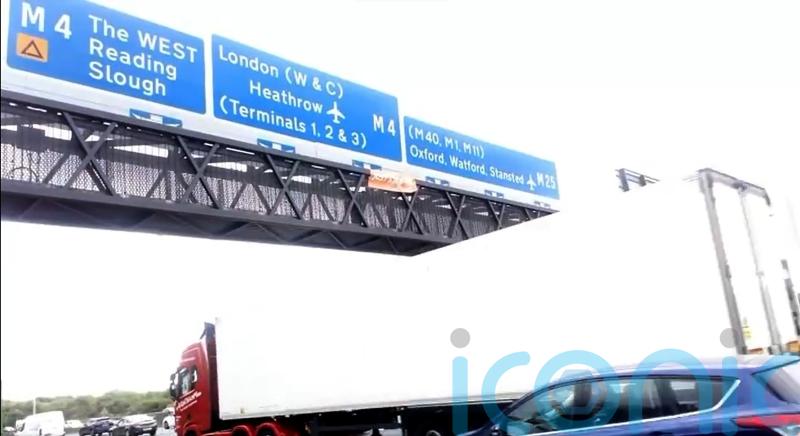 Five arrested as demonstrators climb motorway signs in climate protest