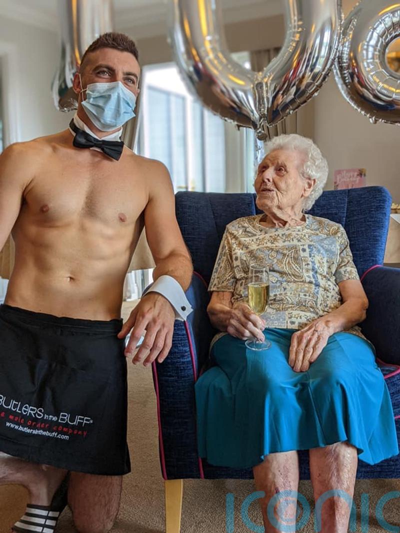 Flirty great grandmother is served glass of bubbly on her 106th birthday by naked butler and she is taken by his “impressive” hairless chest