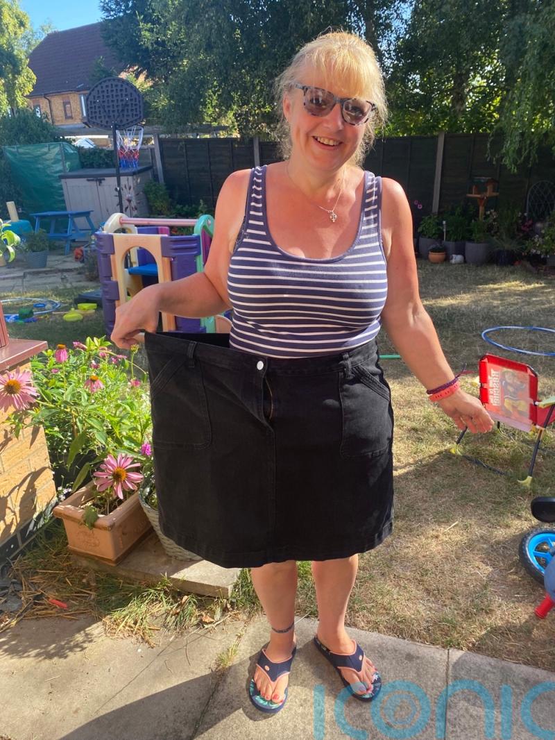 An 18st 6lb childminder who gorges on cheese and chocolate sheds 7st after struggling to fasten size 22 skirt on Boxing Day and likes her body