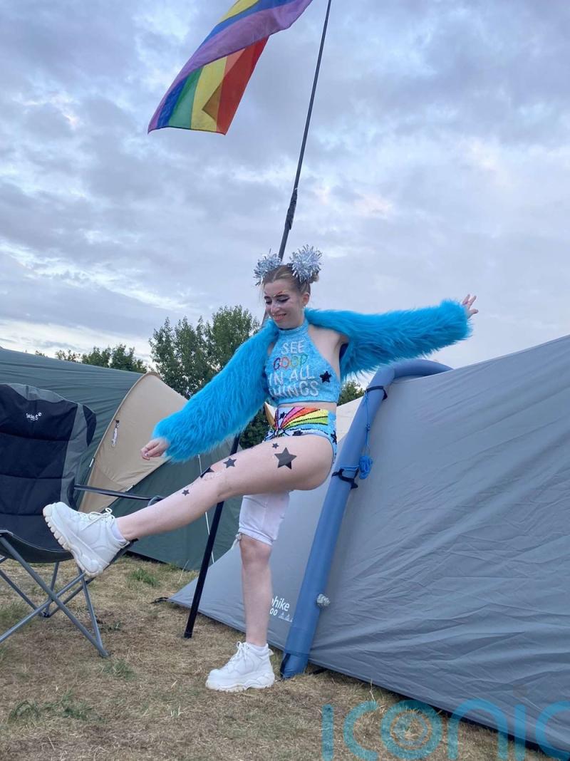 VIDEO: A 24-year-old teams summer festival furry coat and bikini with walking stick and two stoma bags to celebrate surviving bowel cancer
