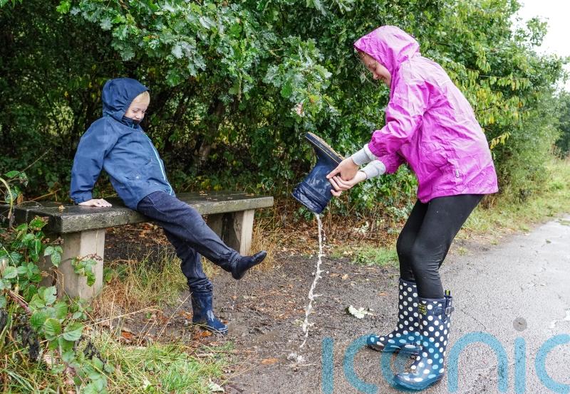 In Pictures: Umbrellas at the ready as dry weather gives way to downpours