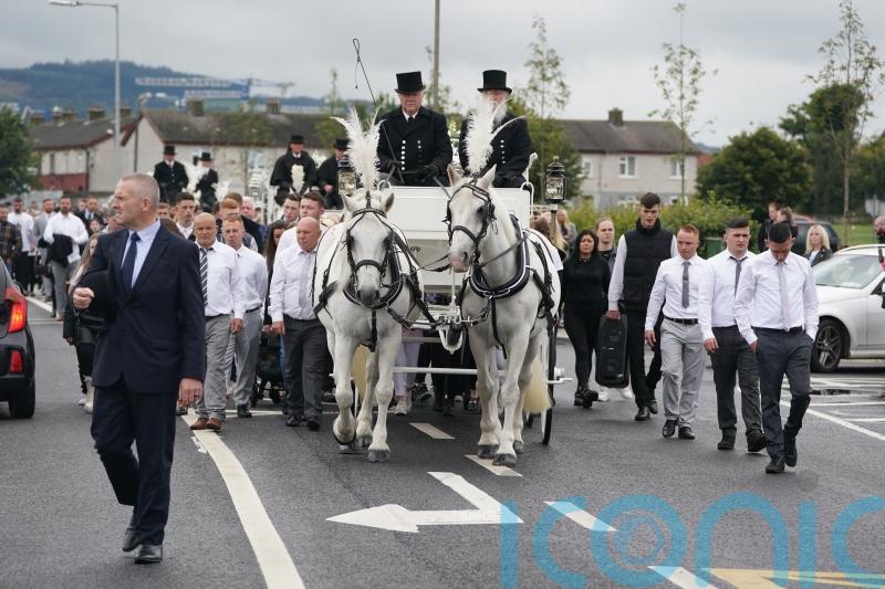 Funeral of three siblings who died in attack in home takes place