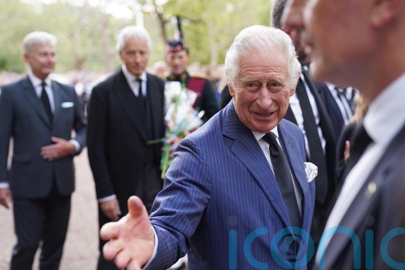 King and Queen shake hands with well-wishers at Clarence House