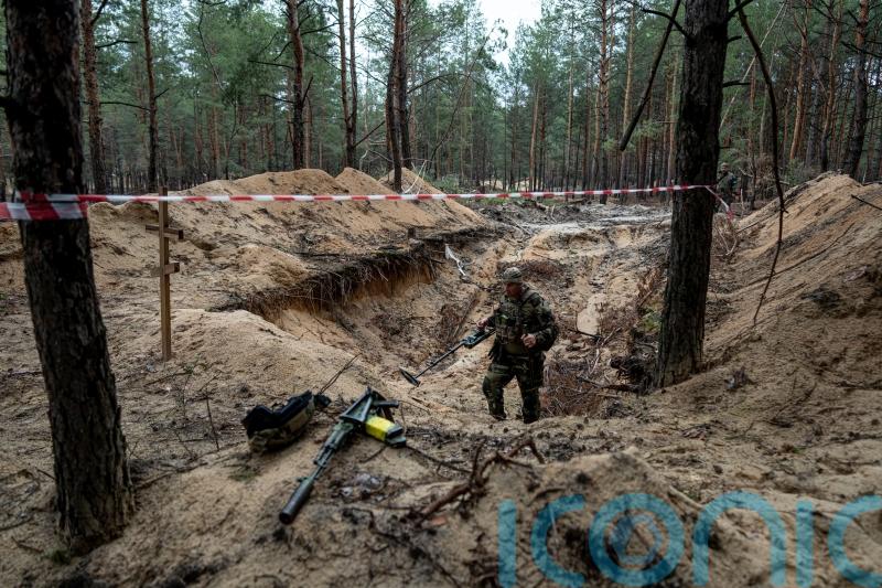 Russia leaves death everywhere, says Zelensky, as Ukraine combs mass burial site