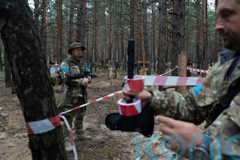 Some bodies in mass burial site in Ukraine show torture signs, says prosecutor