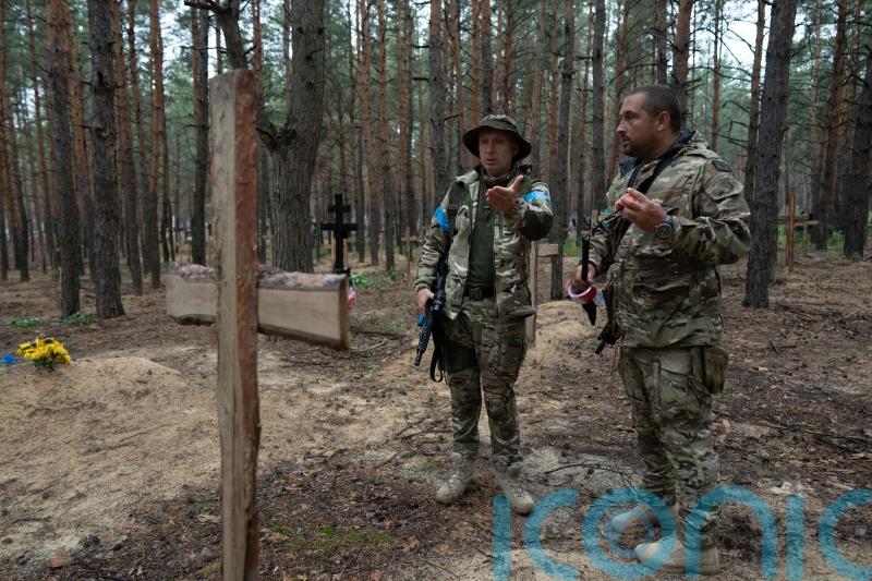 Mass burial site includes torture victims, says Ukraine’s president