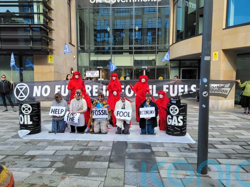 Extinction Rebellion activists dressed in rags and chains protest in Edinburgh