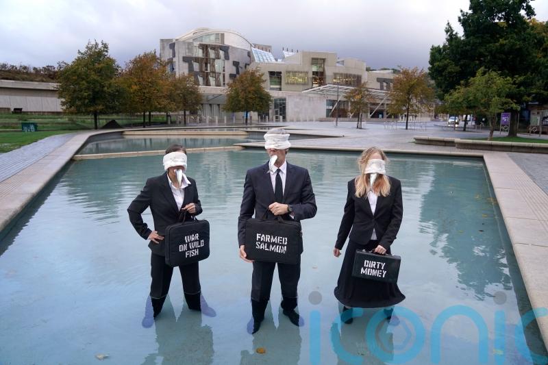 Campaigners protest with dead fish to highlight ‘tragedy’ of salmon industry