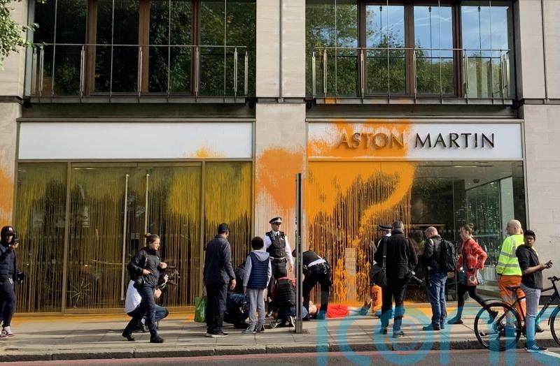 Just Stop Oil supporters spray paint over Aston Martin showroom in London