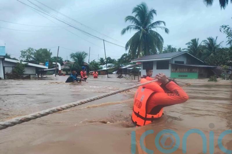 50 dead and dozens feared missing as storm lashes Philippines