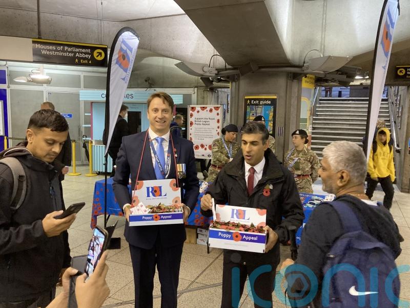Rishi Sunak surprises commuters as he sells poppies in Westminster Tube station
