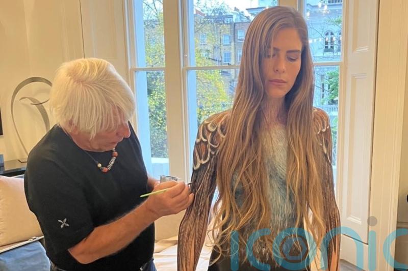 Bird conservationist prepares to march through London wearing only paint