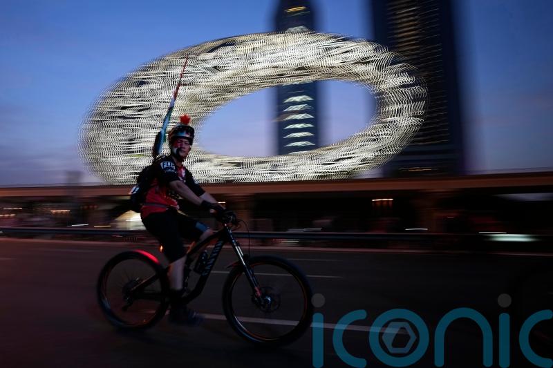 Tens of thousands of cyclists ride on skyscraper-lined superhighway in Dubai