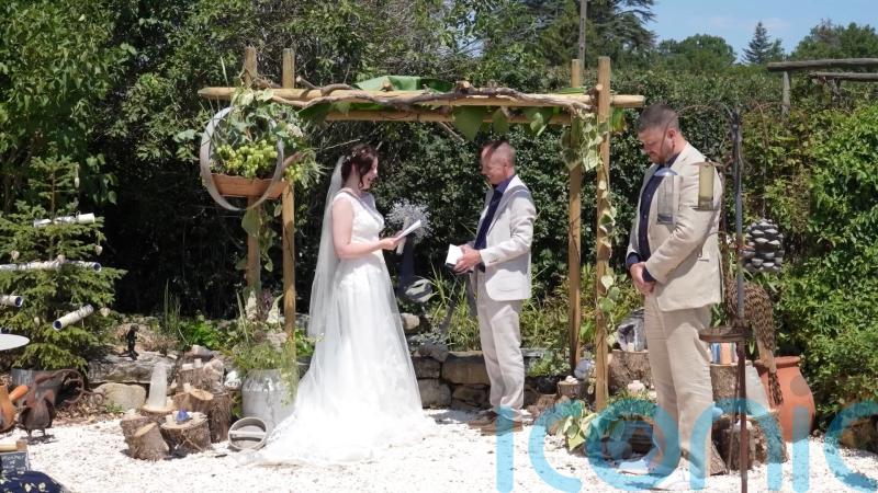 Couple throw festive July wedding in France complete with Christmas trees, crackers and songs