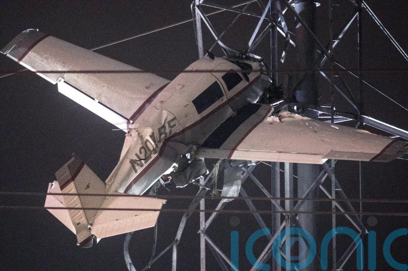 Two rescued from plane caught in power lines