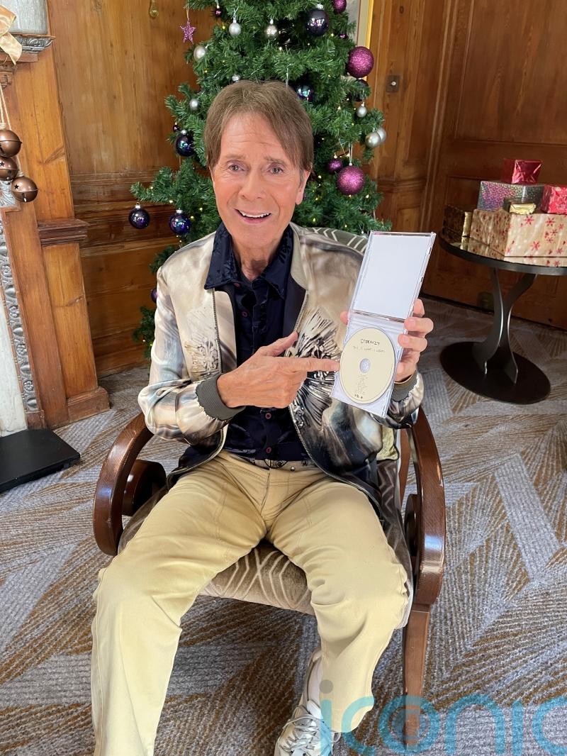 Sir Cliff Richard checks out chart competition as he poses with Stormzy album