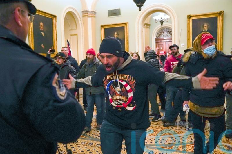 Capitol rioter who led mob chasing police officer is jailed for five years