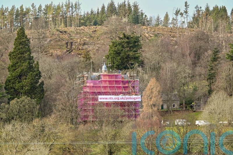 Castle swathed in seven-storeys of pink mesh for conservation work