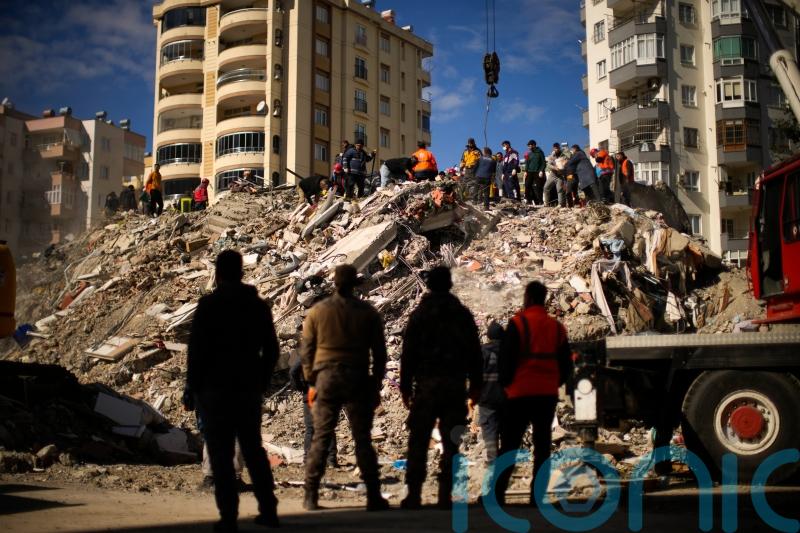 Search teams and emergency aid arrive as earthquake death toll passes 7,700