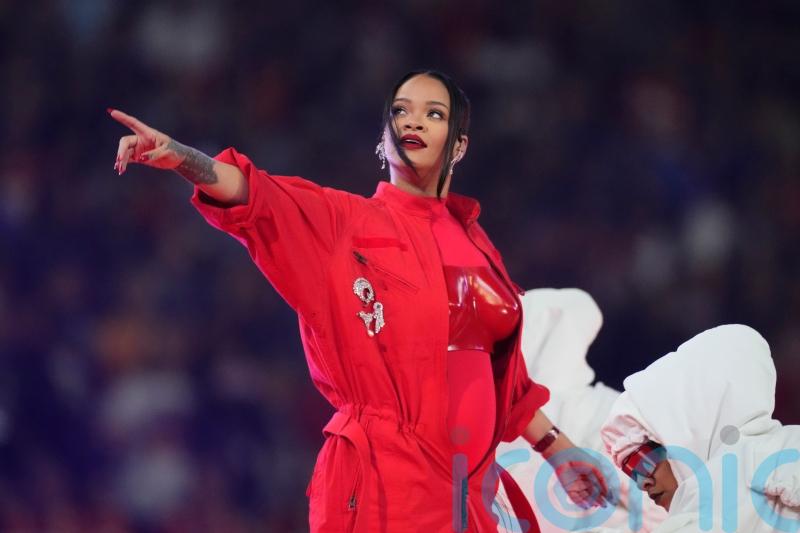 Rihanna appears to reveal pregnancy in guest-free Super Bowl halftime show