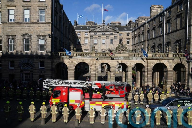 Royal Mile falls silent as thousands pay tribute to fallen firefighter