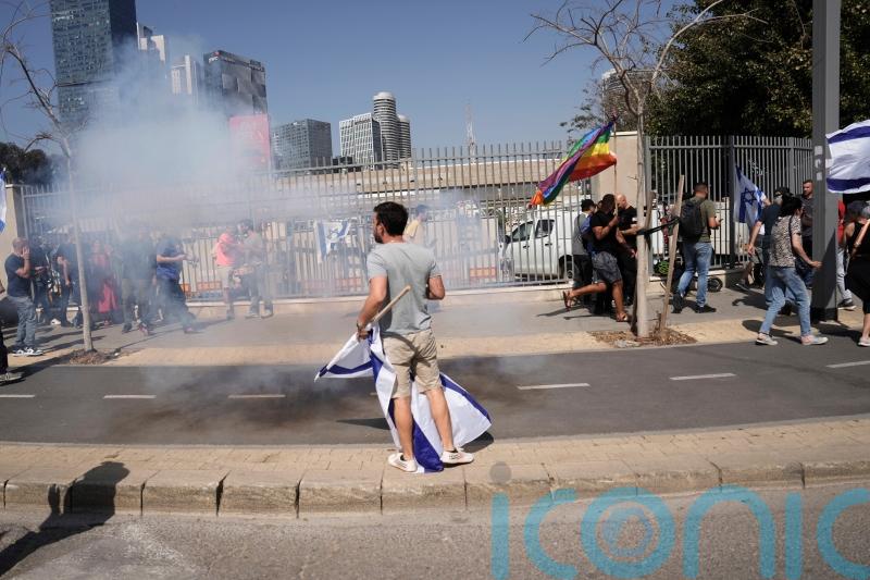 Protests over legal overhaul in Israel turn violent as police fire stun grenades