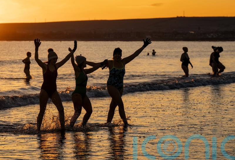 Sub-zero temperatures fail to deter swimmers from sunrise dip
