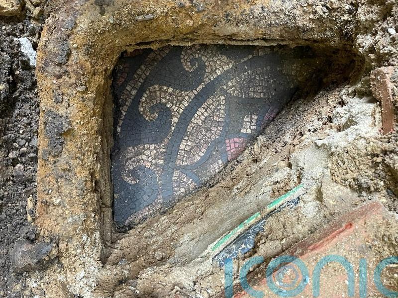 Work starts to unearth mosaic under pavement outside vape shop