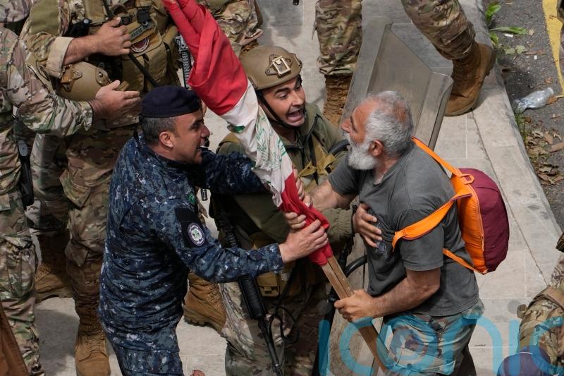 Security forces fire tear gas as Lebanon protesters try to storm government HQ