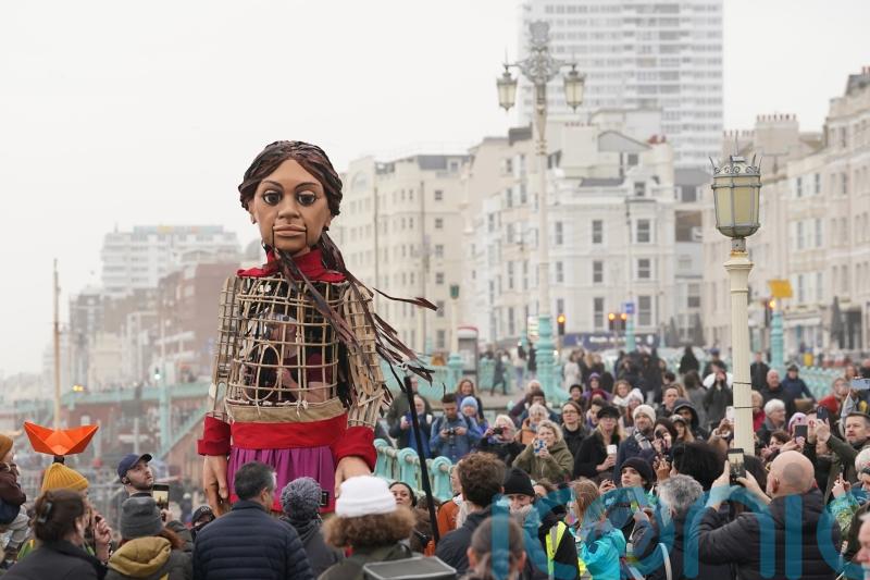 Giant puppet Little Amal leads walk in Brighton to raise awareness of refugees