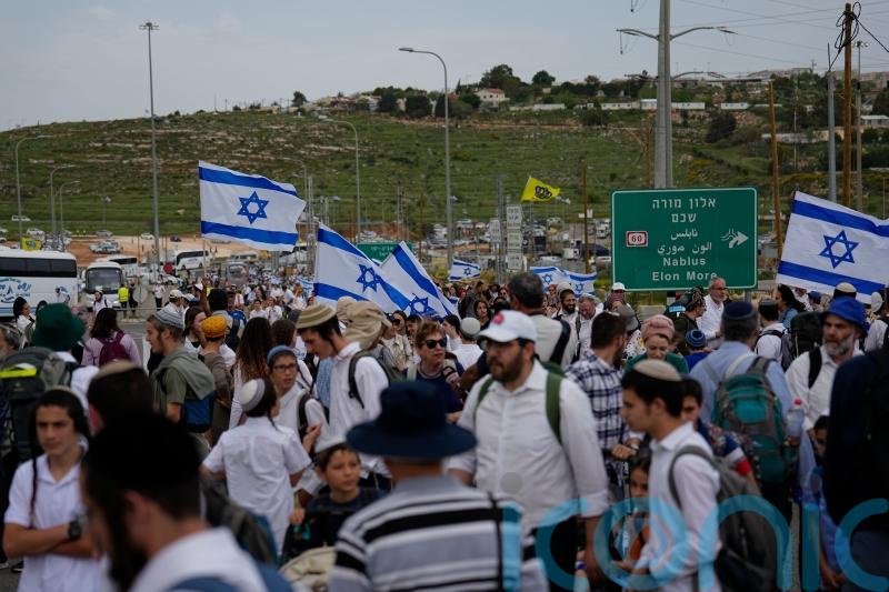 Defiant Jewish settlers march to evacuated West Bank outpost